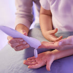 Applying POM Calm Balm to hands