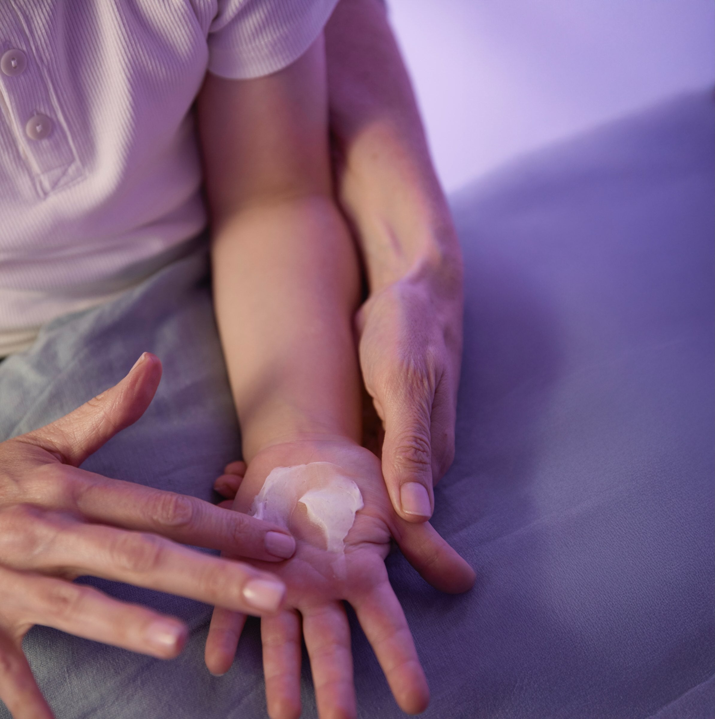 POM Calm Balm being massaged in to child's hand.