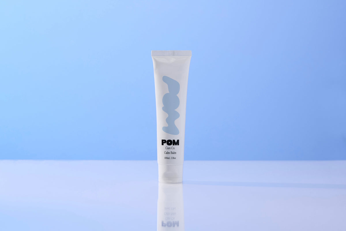 POM Calm Balm tube on Blue Background