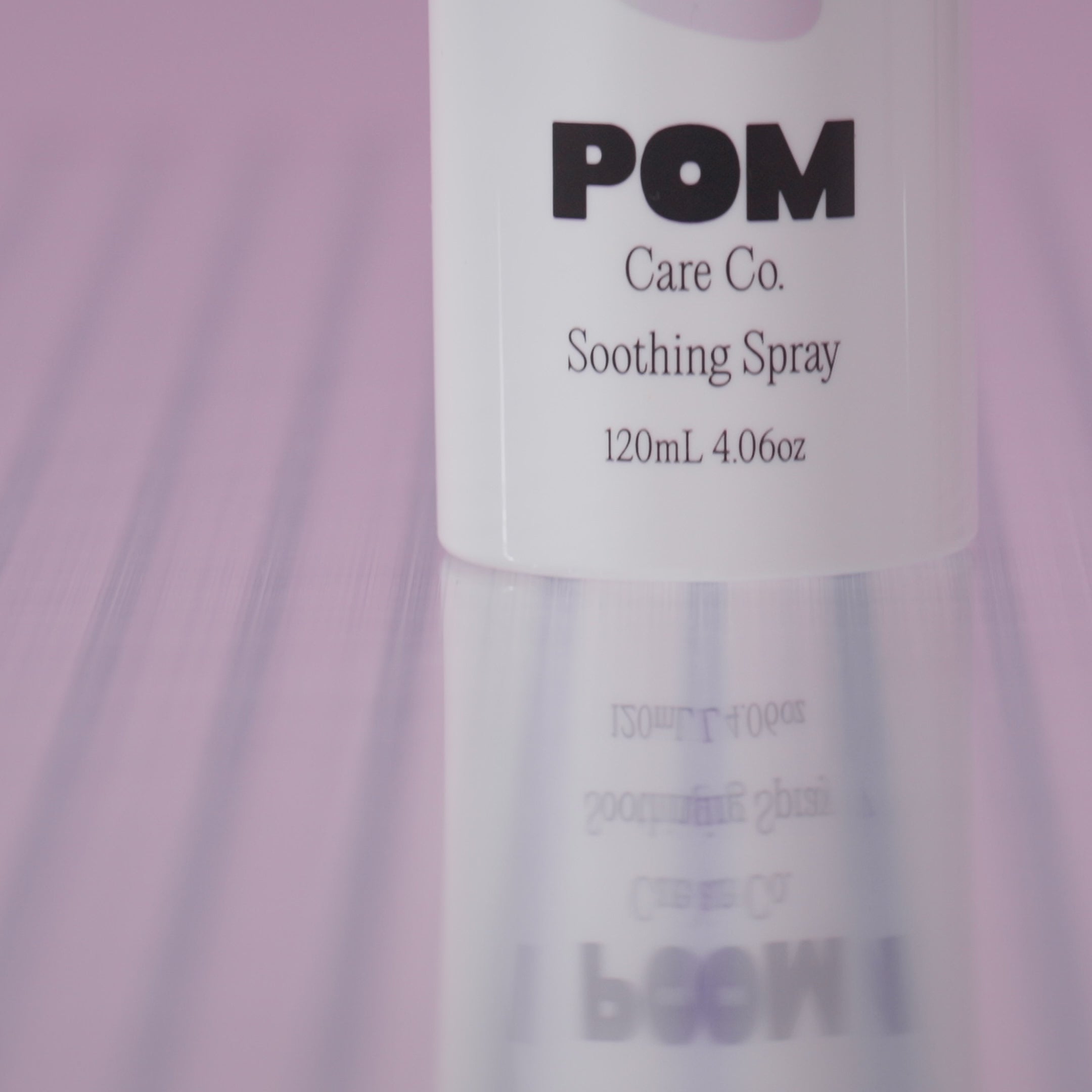 POM Soothing Spray displayed against a purple background.