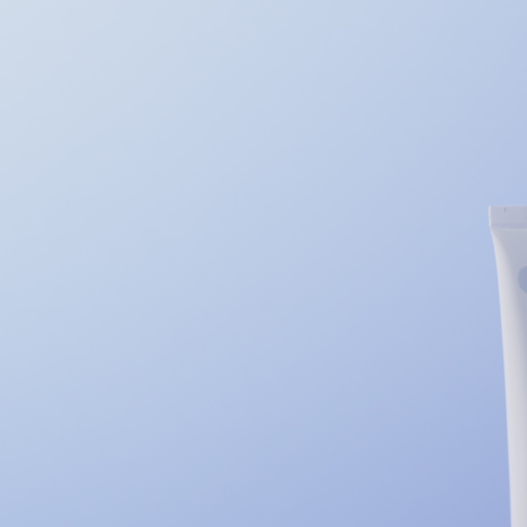POM Calm Balm tube displayed against a soft blue background.